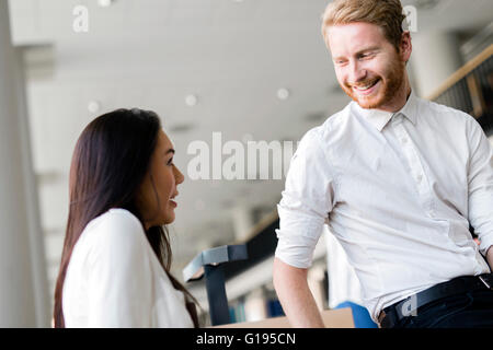 A group of academics studying in the library and conversing in a positive mood Stock Photo