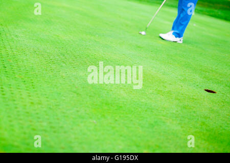 Golfer ready to take the shot on the putting green Stock Photo