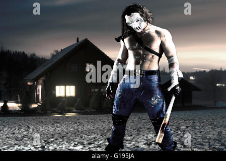 Costumed hero as a street maniac with a bat. Casey Jones in Alps. Combined image - studio work was added to real landscape. Stock Photo