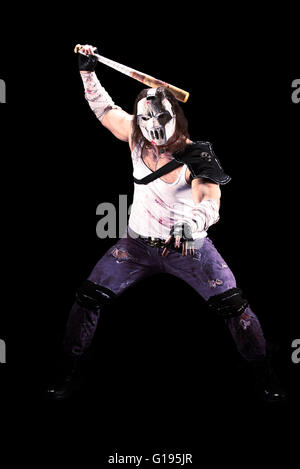 Costumed hero as a street maniac with a bat. Casey Jones on black background. Stock Photo