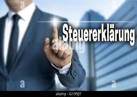 steuererklaerung (in german tax declaration) touchscreen is operated by businessman. Stock Photo