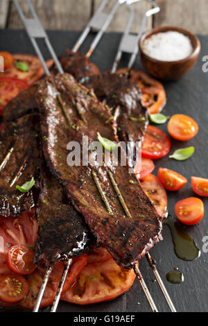Flank steak on skewers with tomatoes Stock Photo