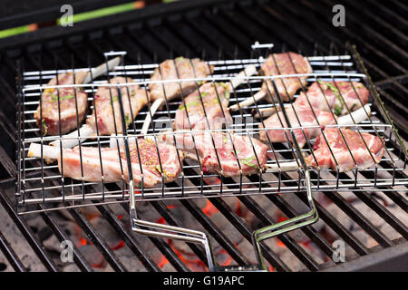 Lamb chops in grilling basket on grill Stock Photo