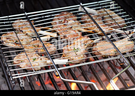 Lamb chops in grilling basket on grill Stock Photo