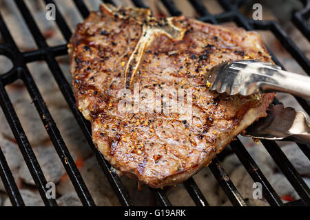 Beef steak being cooked on a grill Stock Photo