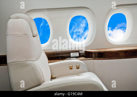 Aircraft porthole with clouds view Stock Photo