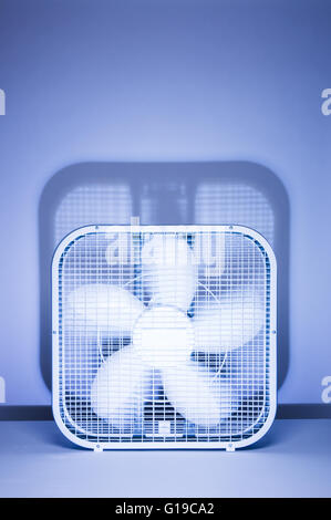 Box fan in motion, spinning blades shot in the studio with a distinct ...