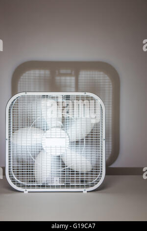 Box fan in motion, spinning blades shot in the studio with a distinct ...