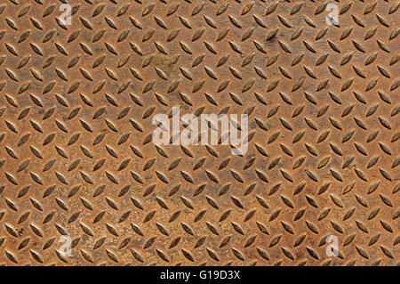 old rusty diamond tread non skid metal plate background Stock Photo