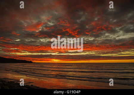 sunset over the Pacific Ocean in Punakaiki New Zealand Stock Photo