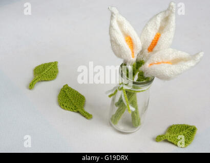 Romantic desk with ornament from handmade product, lily flower knit from white yarn, handbook, knitting knitting beautiful craft Stock Photo