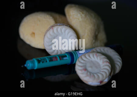 Insulin pen with blood sugar meter & test strip,used in the treatment of Diabetes mellitus.High carbohydrate foods also featured Stock Photo