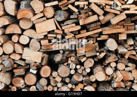 Stack of chopped firewoods prepared for winter. Wooden background Stock Photo