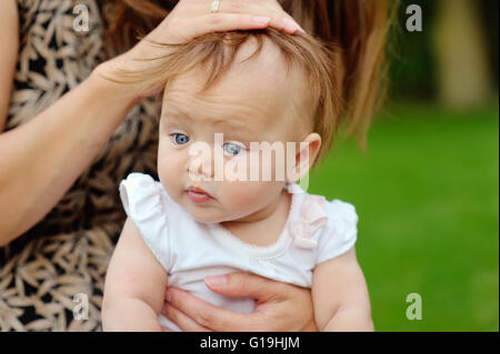 Summer portrait of beautiful baby girl on the lawn Stock Photo