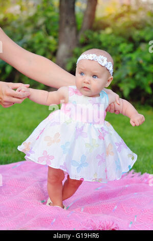 baby girl outdoors in a dress Stock Photo