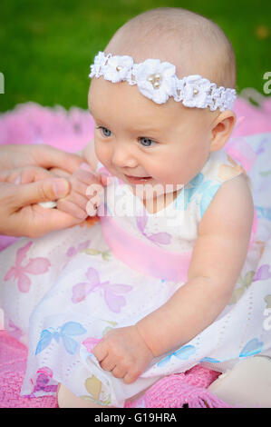 happy smiling cheerful baby girl in pink hood with ears Stock Photo