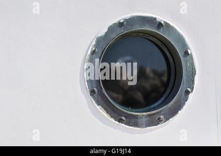 Porthole in the white hull of passenger ship. Marine  background Stock Photo