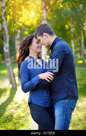 Romantic Teenage Couple By Tree In Autumn Park Stock Photo