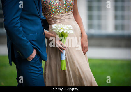 Beautiful wedding bouquet in hands of the bride Stock Photo