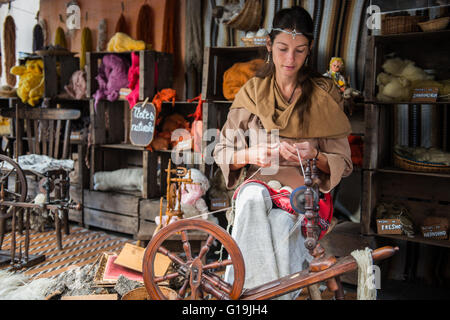 Woman Spinner working on a stand outdoors Stock Photo