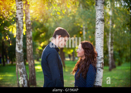 Man embraces girl on a walk in the autumn park Stock Photo