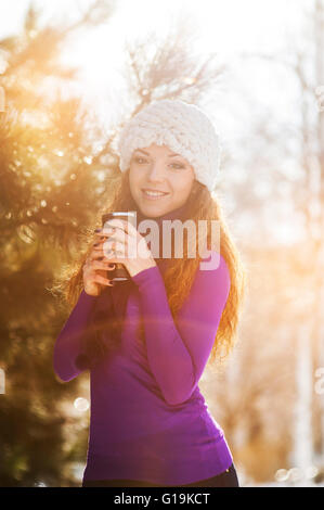 Beautiful happy girl in the red jacket in the winter. Stock Photo