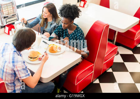 Friends eating at the table in the diner
