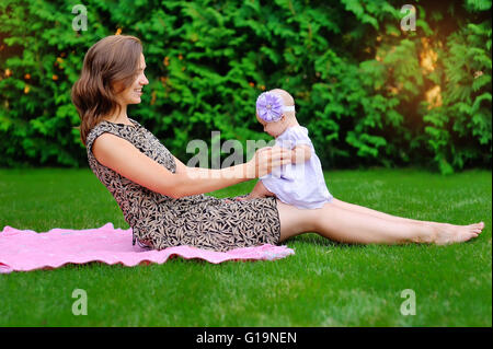 Beautiful Mother And Baby outdoors. Nature. Beauty Mum and her C Stock Photo