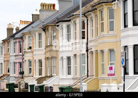 Brightly painted terraced houses on Queens Park Road Brighton Sussex UK Stock Photo