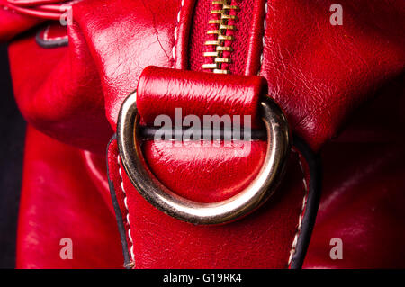 closeup of the fittings on the red leather hand bag Stock Photo