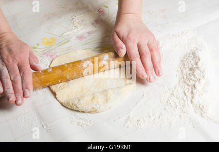 Making dough by female hands on wooden table background Stock Photo