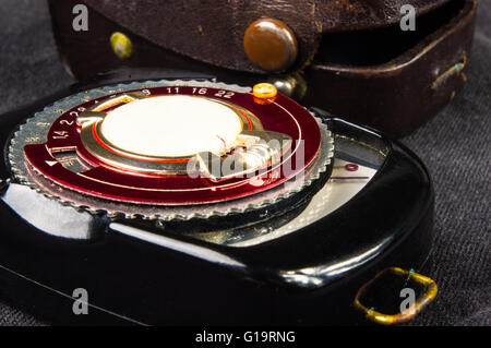 old vintage Soviet exposure meter with leather case on black background Stock Photo