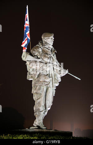 A floodlit Royal Marines 'Yomper' memorial statue at the former Royal Marines Barracks, Eastney, Portsmouth, UK on the 11th May 2016. Stock Photo