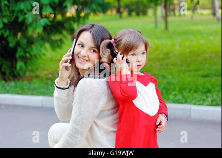 Mom with baby talking on phone Stock Photo