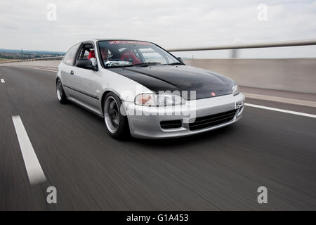 Modified fifth generation or 'EG' Honda Civic driving Stock Photo