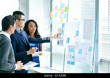 Asian business executives analyzing annual report Stock Photo
