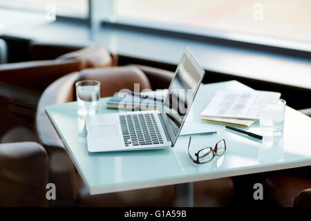 Laptop and other business objects on office table Stock Photo