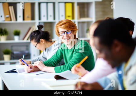 Laughing student looking at his friends during lecture Stock Photo