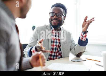 Happy African businessman consulting with colleague Stock Photo