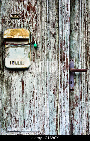 old weathered wooden door detail with mailbox Stock Photo