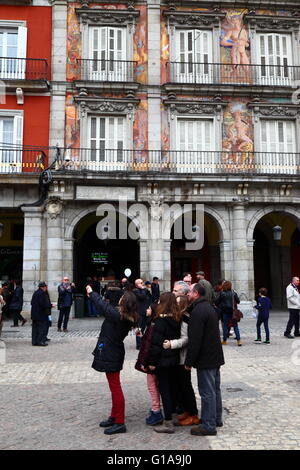 Tourists taking selfies in front of Casa de la Panaderia, Plaza Mayor, Madrid , Spain Stock Photo