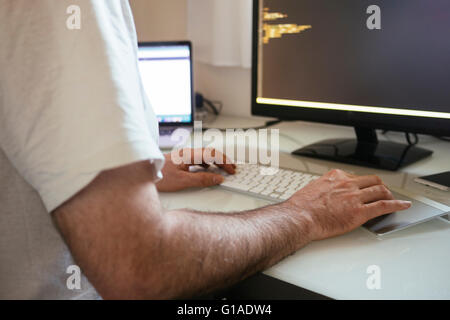 Web-developer writing code in home office. Stock Photo