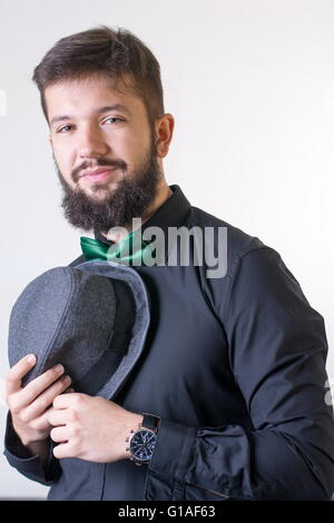 Fashionable man in a black shirt with a bow tie Stock Photo