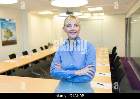 Portrait of pretty business woman in meeting room Stock Photo