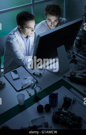 Engineering students in the laboratory, they are working with a computer, innovation and technology concept