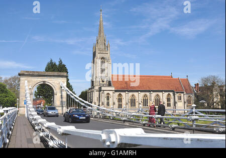 Bucks - on Marlow 19c suspension bridge - view to All Saints parish church - traffic and walkers -  spring sunshine + blue sky Stock Photo