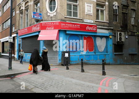 Muslim women walking along Shoreditch High Street near French Place in Shoreditch, East London UK  KATHY DEWITT Stock Photo