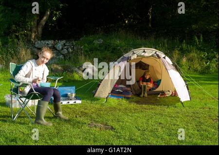 Children eating breakfast  at  a campsite in Eskdale in the English Lake District Stock Photo