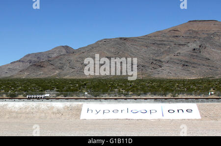 Las Vegas, Nevada, USA. 11th May, 2016. A test sled runs on rails during a propulsion open-air test of Hyperloop One's transportation technology, in Nevada, U.S. May 11, 2016. Hyperloop One stages the first public demonstration of a key component of the startup's futuristic rail transit concept that could one day ferry passengers at near supersonic speeds. © Guo Shuang/Xinhua/Alamy Live News Stock Photo