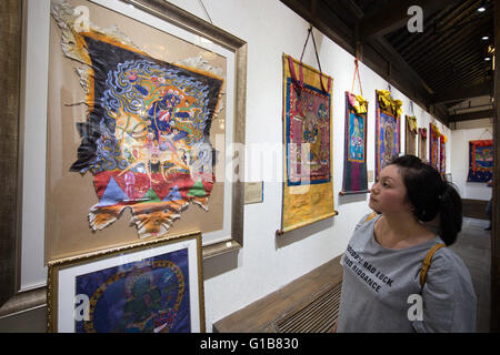 Nanjing, Nanjing, CHN. 12th May, 2016. Nanjing, China - May 12 2016: (EDITORIAL USE ONLY. CHINA OUT ) Thangka Exhibition from Gongka County Mozhu Yibet in Nanjing's Yu Garden. A thangka, variously spelt as tangka, thanka or tanka (Nepali pronunciation: [?t??a?ka]; Tibetan: ?????; Nepal Bhasa: ????) is a Tibetan Buddhist painting on cotton, or silk appliquÂ¨Â¦, usually depicting a Buddhist deity, scene, or mandala. Thangkas are traditionally kept unframed and rolled up when not on display, mounted on a textile backing somewhat in the style of Chinese scroll paintings, with a further silk cover Stock Photo